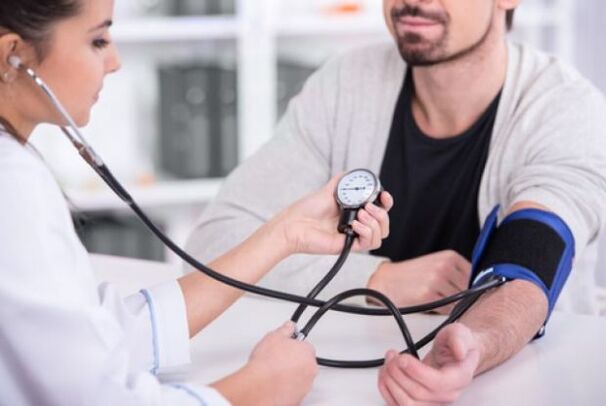 the doctor measures the blood pressure in hypertension